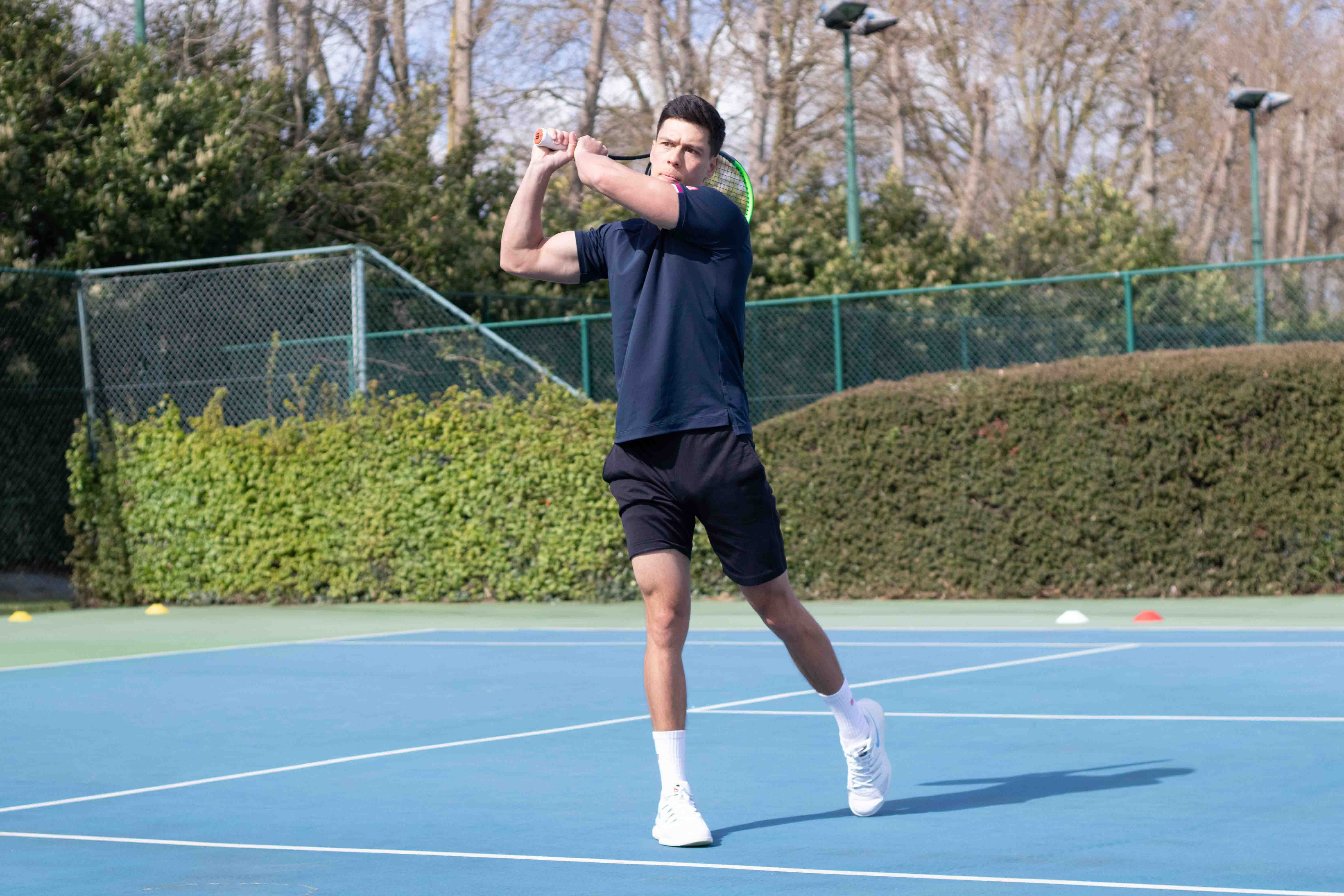 Man swinging a tennis racquet at Virgin Active