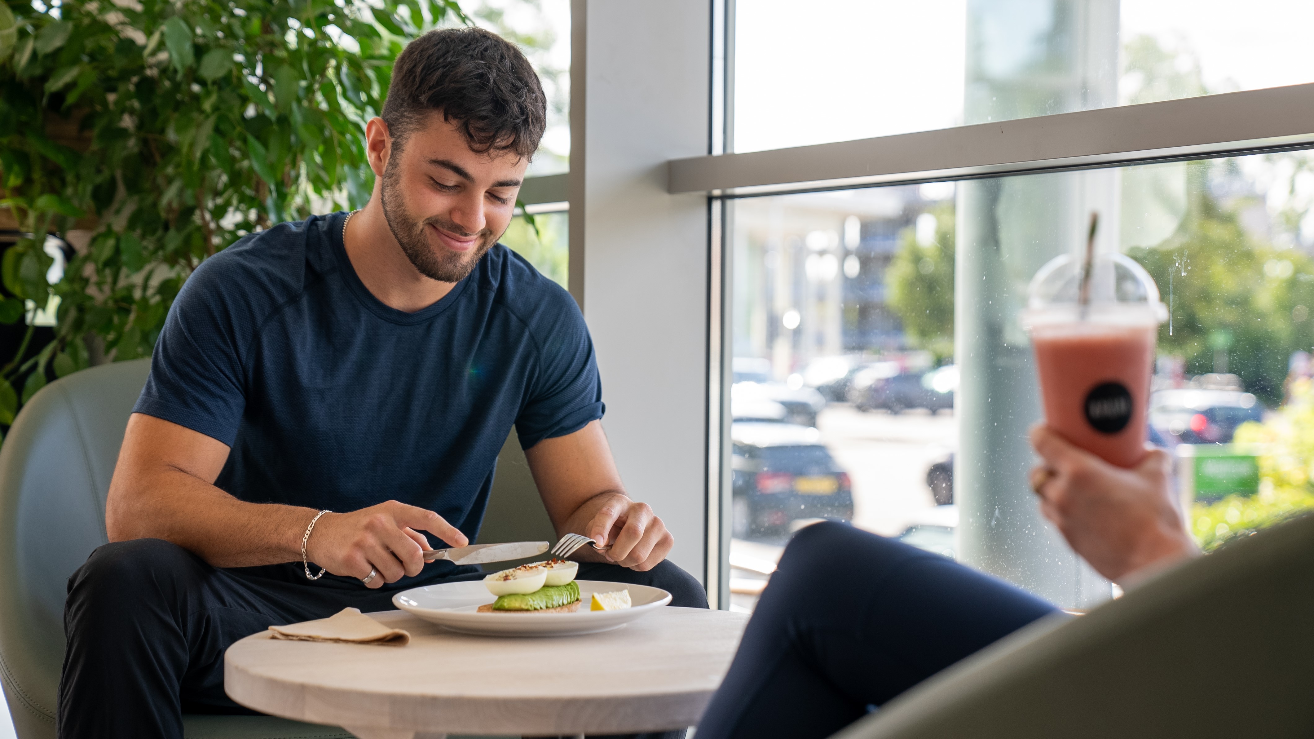 Virgin Active Mill Hill Kauai café man eating and talking to lady