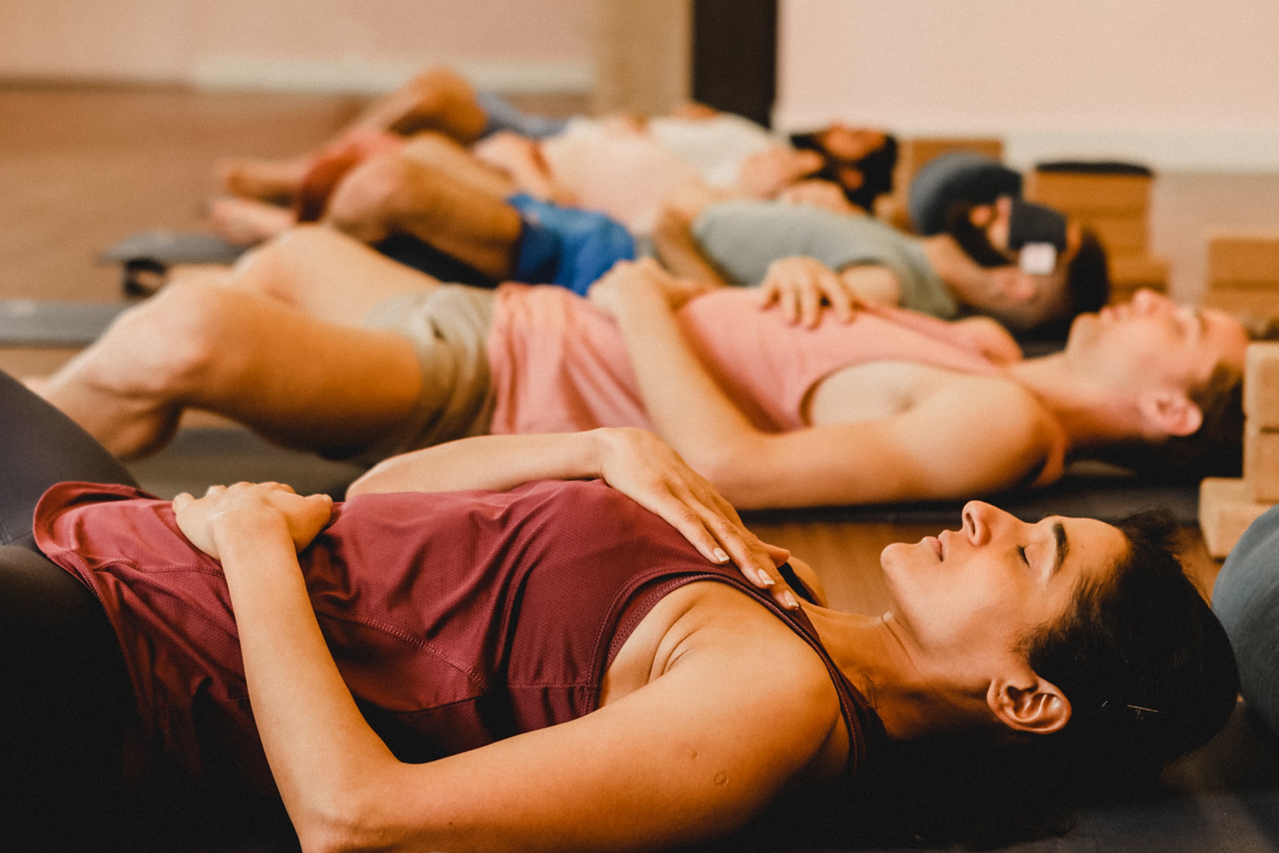 Group Yoga class laying down practicing relaxation Yoga at Virgin Active.